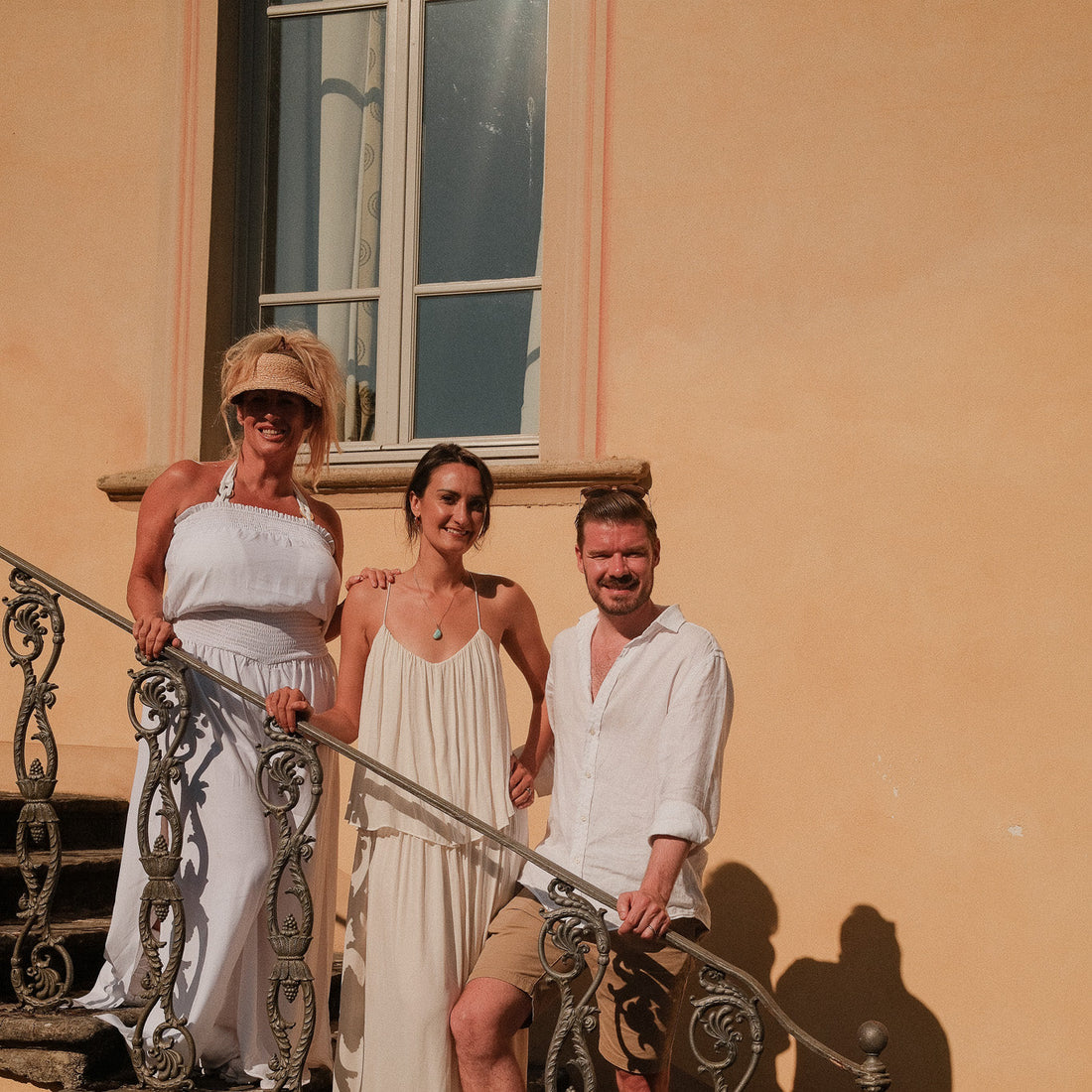 Tina Pavlou, Jessica Hayden-Smith and Samuel Hayden-Smith, co-founders of Bower Botanicals, on the villa steps at their retreat in Italy